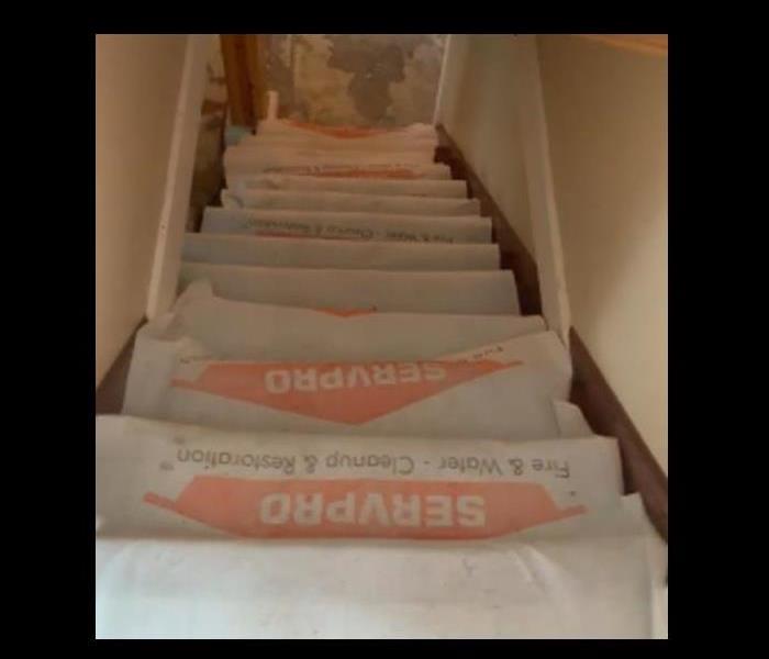 stairs with servpro paper covering